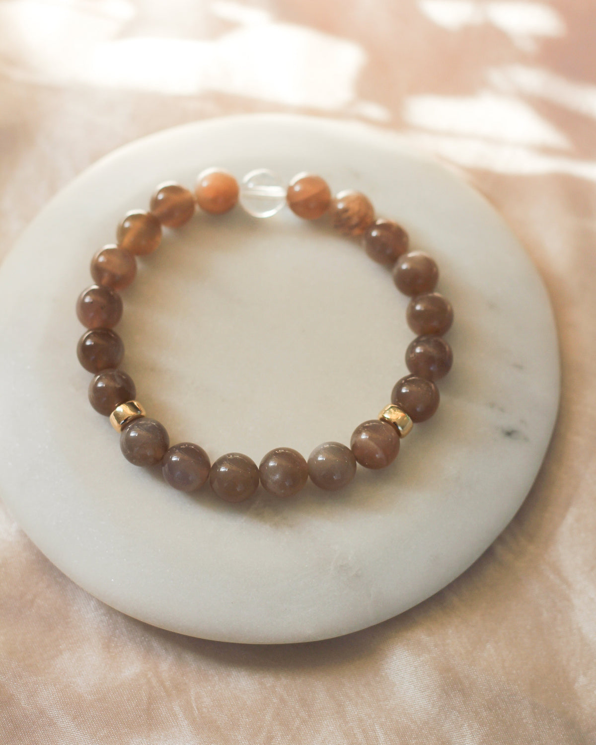 Close-up of round 8mm Coffee Moonstone gemstone beads in warm, earthy brown tones.