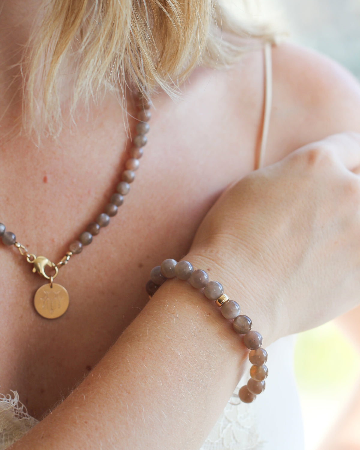 Coffee Moonstone stretch beaded bracelet with 8mm round gemstones, worn on the wrist.