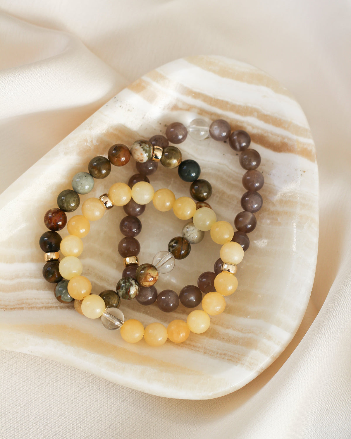Coffee Moonstone beaded bracelet stacked with other natural gemstone bracelets.