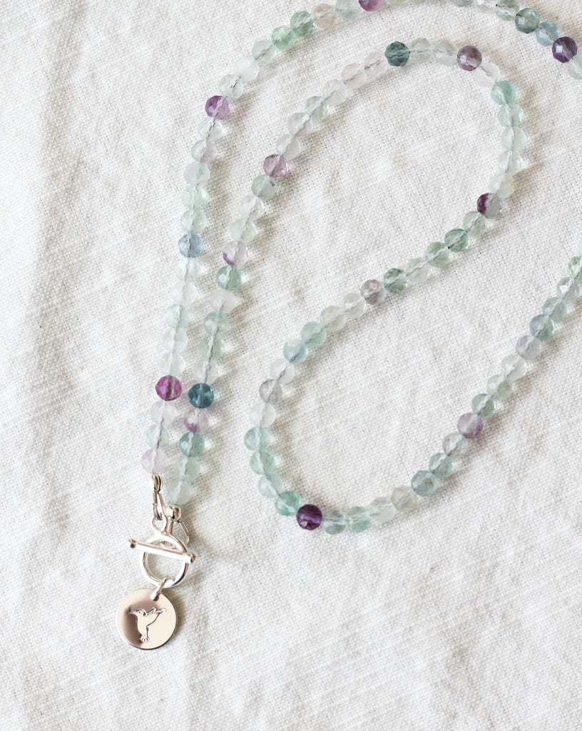 fluorite intention necklace with silver hummingbird charm