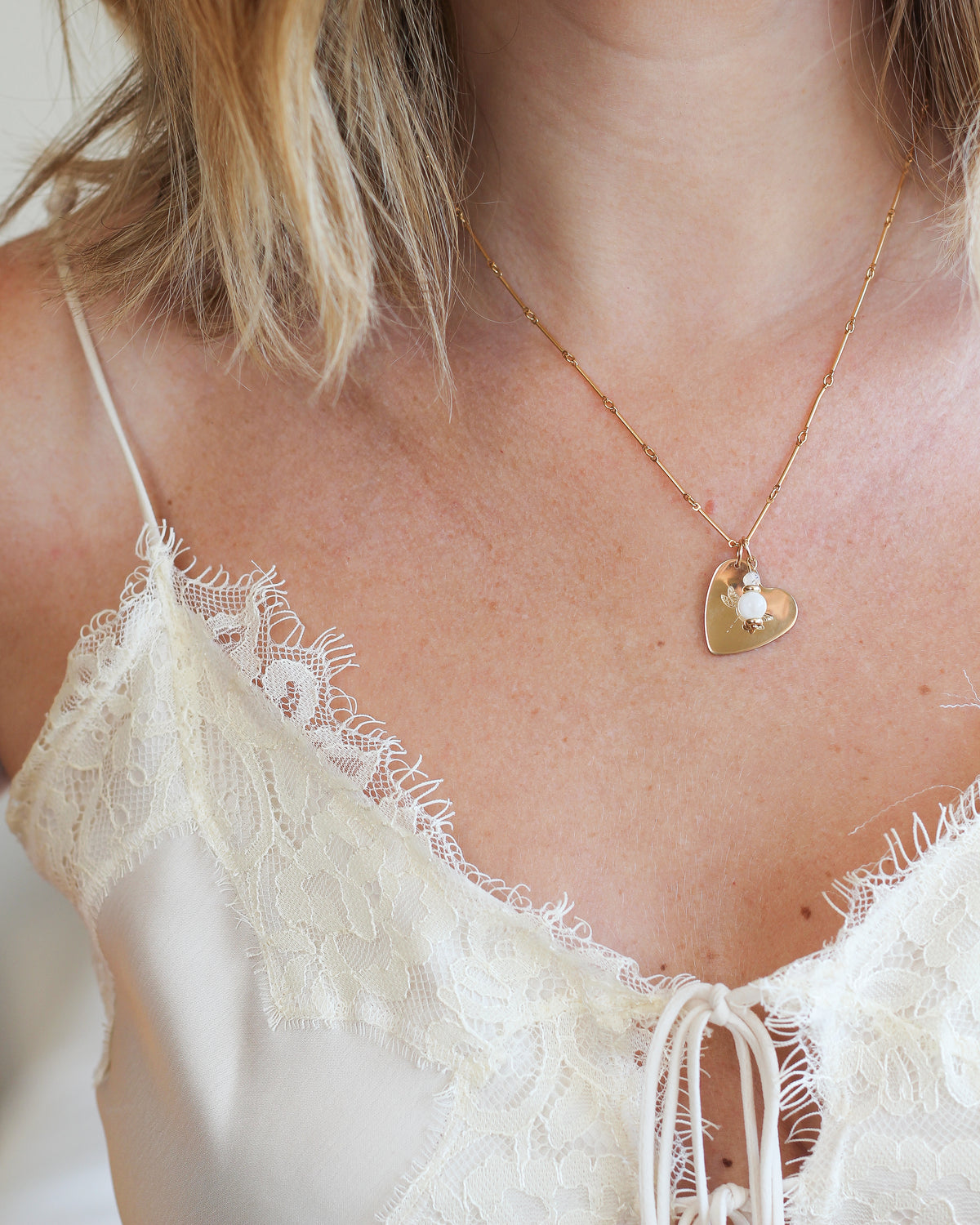 gold fill bar chain worn around the neck with charms