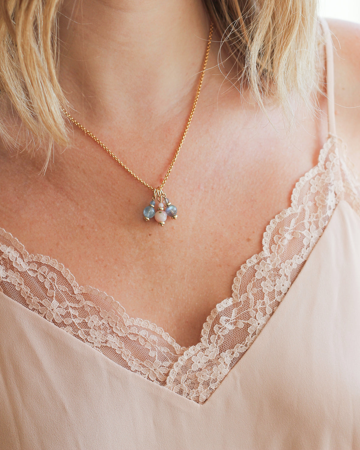 14k gold-fill rolo chain worn around the neck with charms