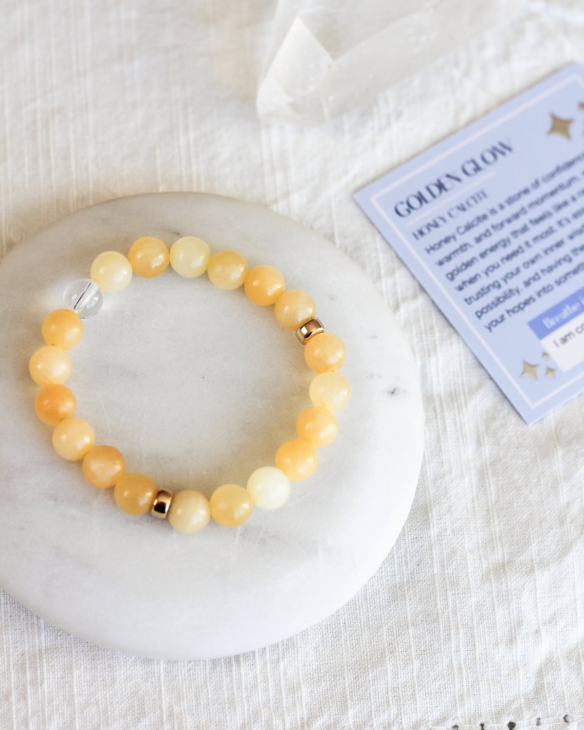 Close-up of round 8mm Honey Calcite gemstone beads in warm golden yellow tones.