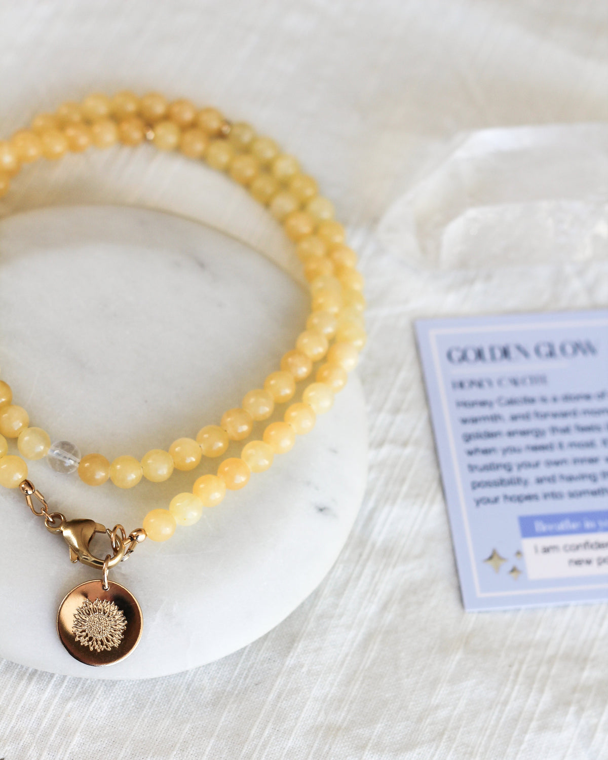 Close-up of round 6mm Honey Calcite gemstone beads in warm golden yellow tones.