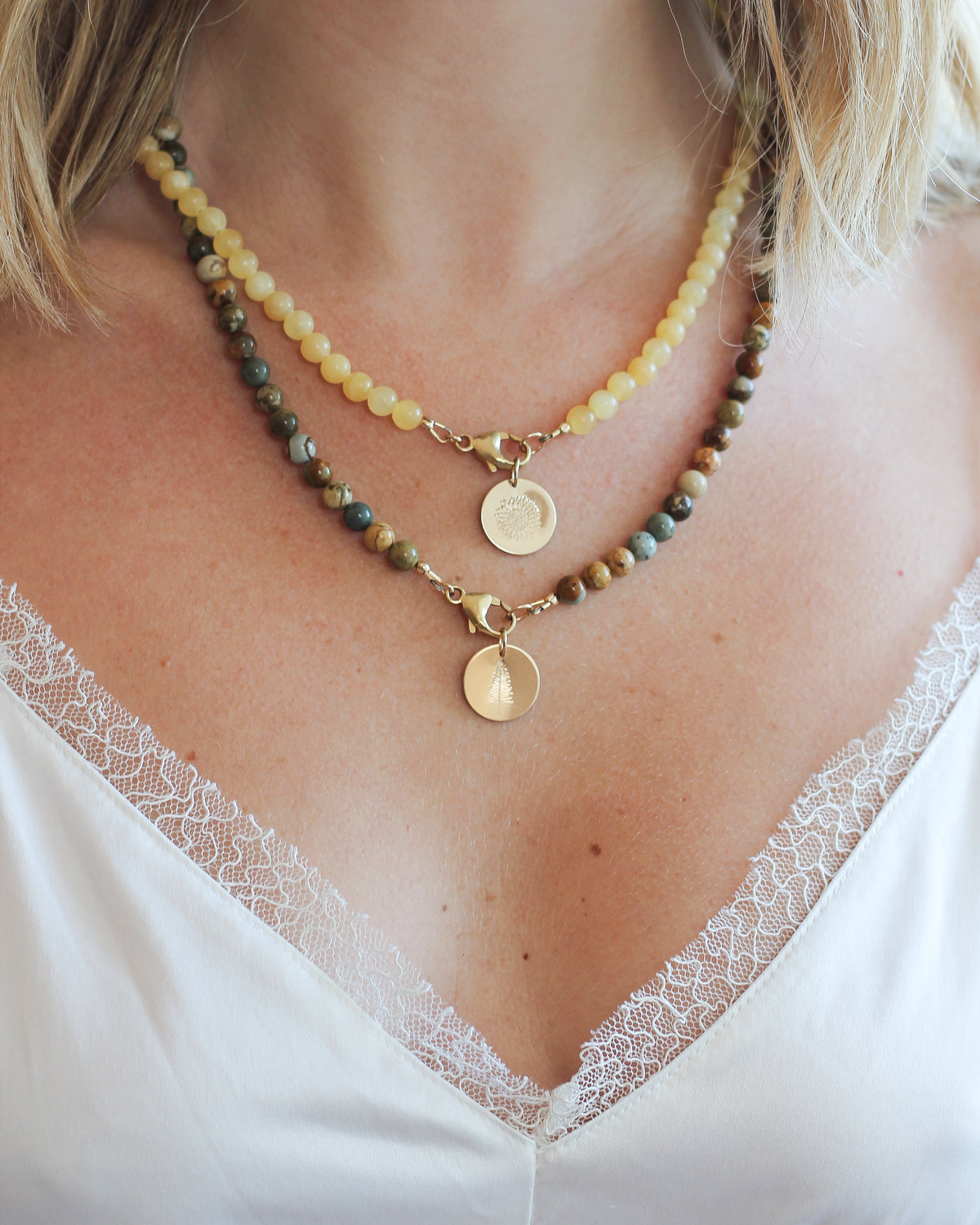 Jasper beaded necklace layered with other gemstone necklaces.