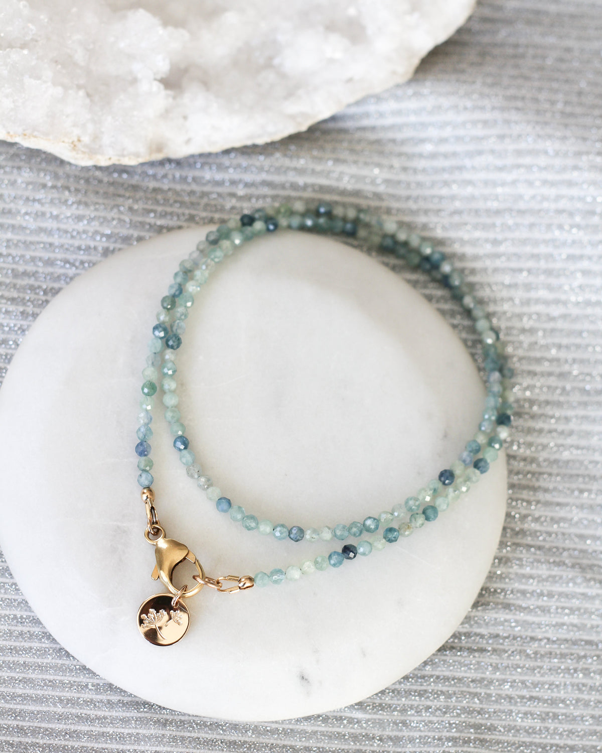 Close-up of delicate 3mm faceted bicolour Kyanite gemstone beads.