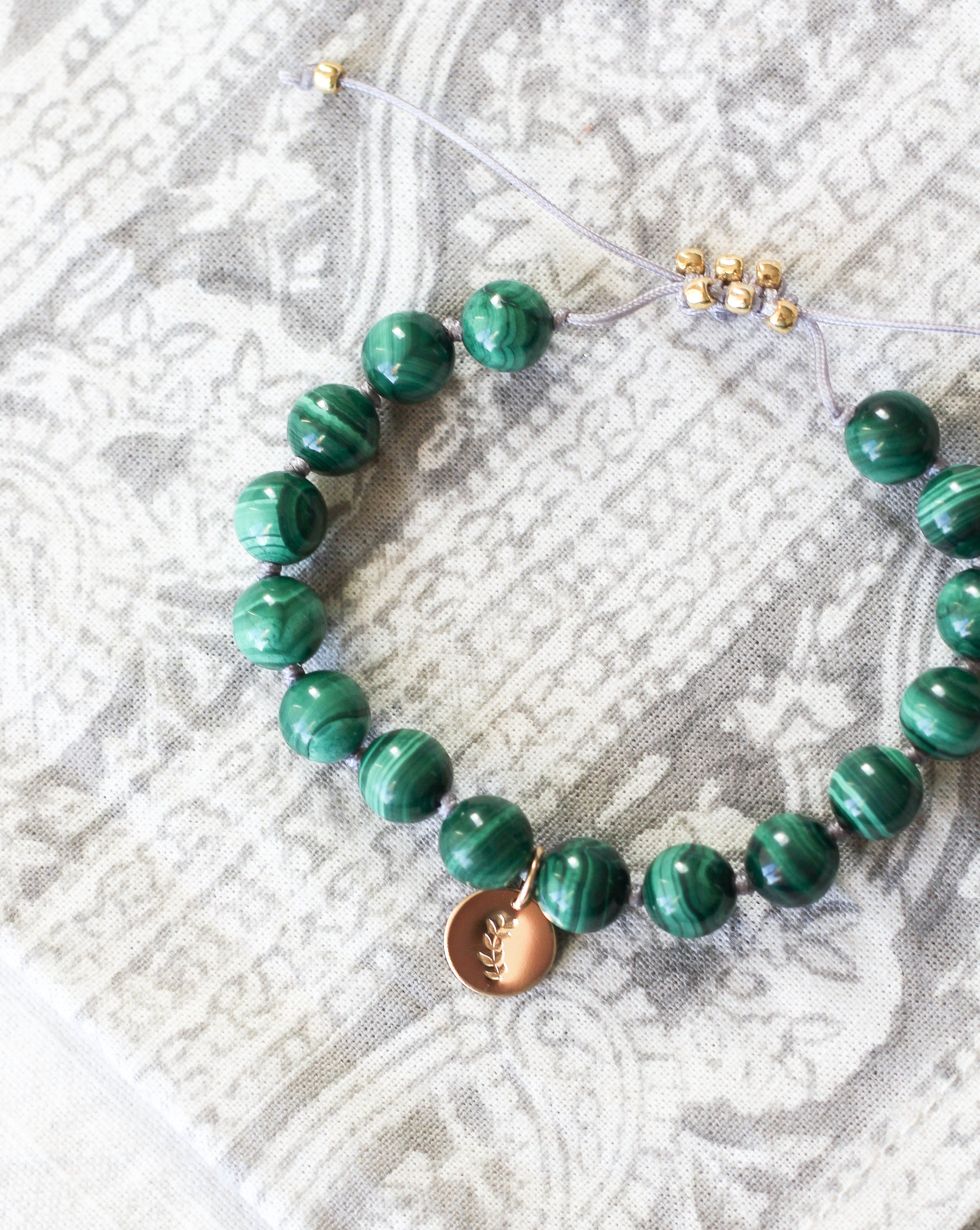 malachite mala bracelet with gold charm