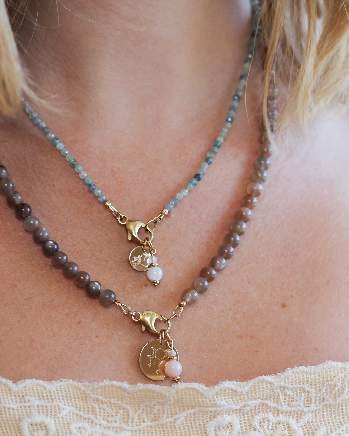 Moonstone gemstone charm styled on a gemstone beaded necklace.