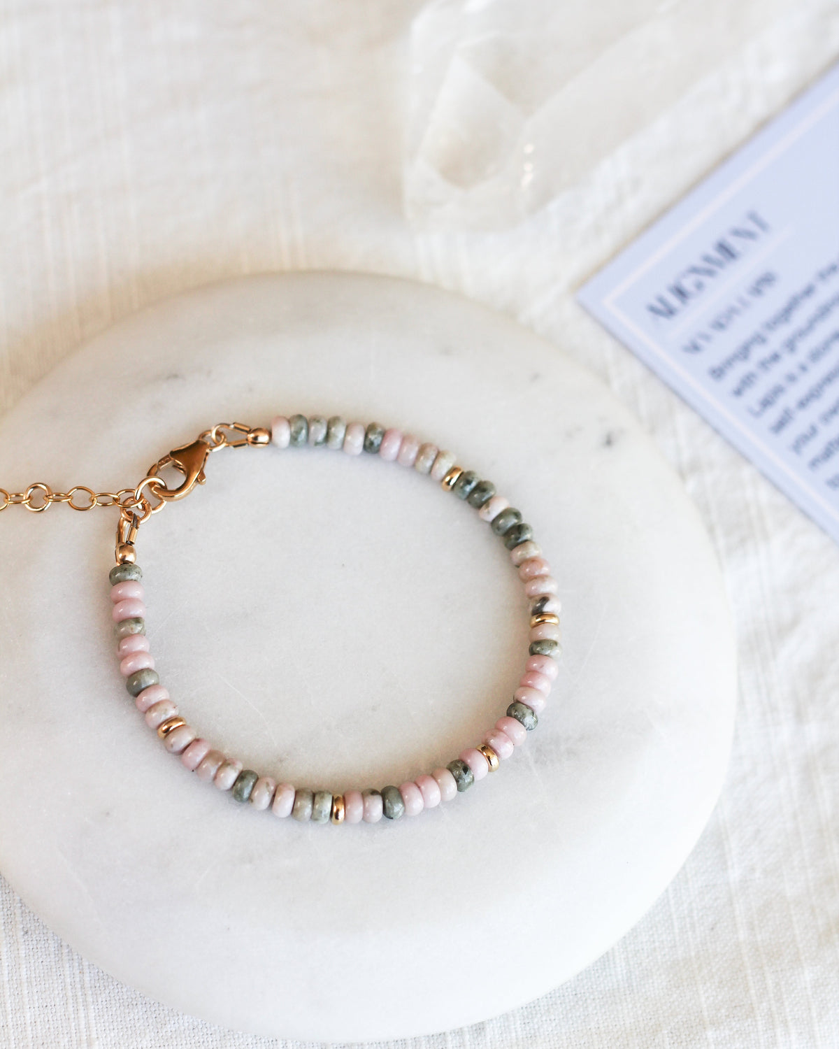 Handmade Nevada Lapis beaded bracelet featuring natural pink and green gemstones.