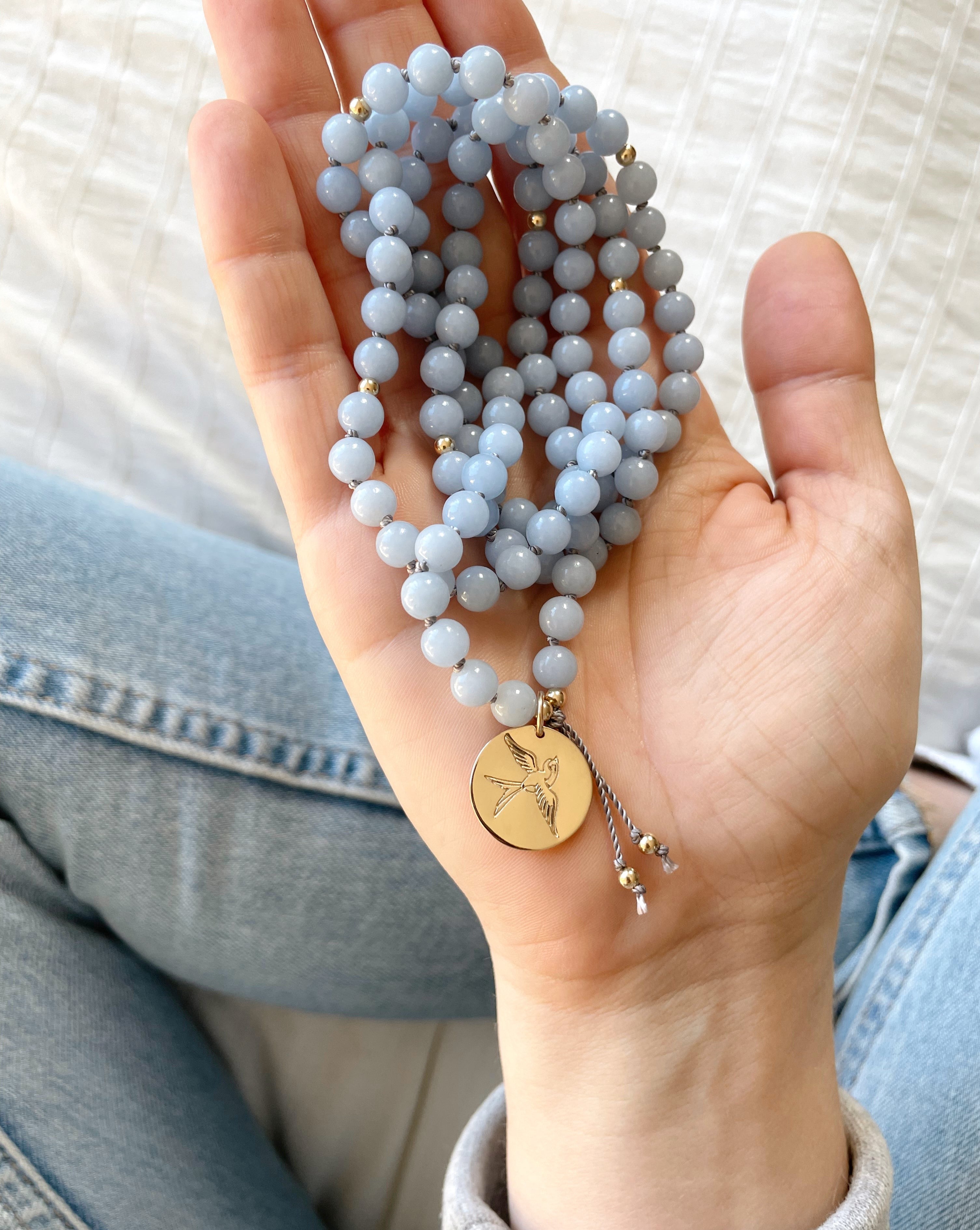 angelite mala pendant necklace in hand