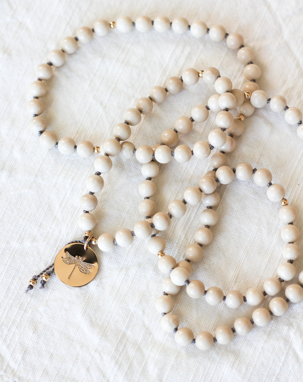 riverstone mala pendant necklace with dragonfly medallion