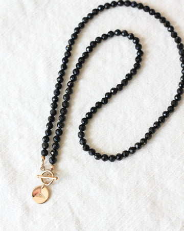 black tourmaline intention necklace with gold mountain charm
