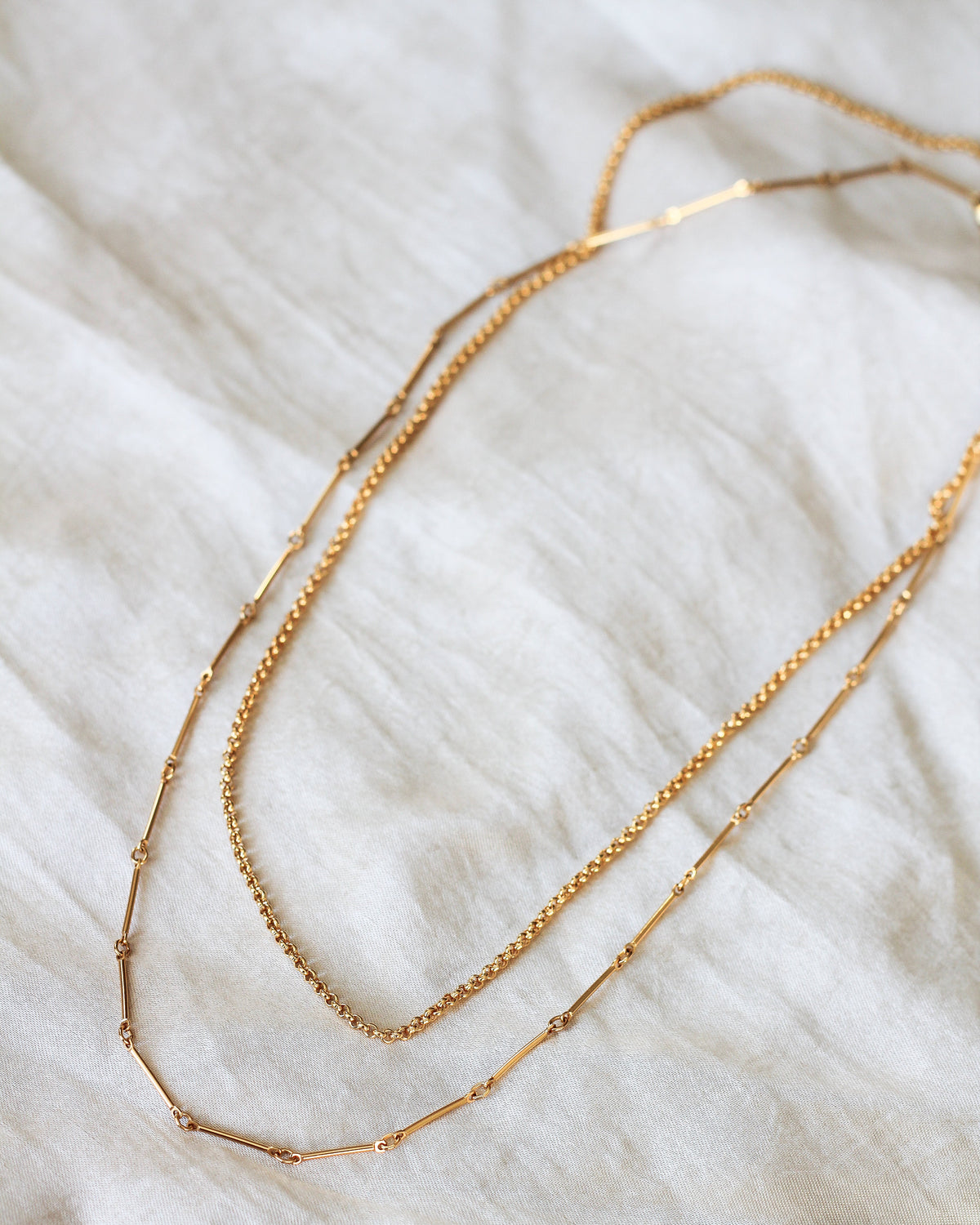 gold rolo chain layered with other gold chain