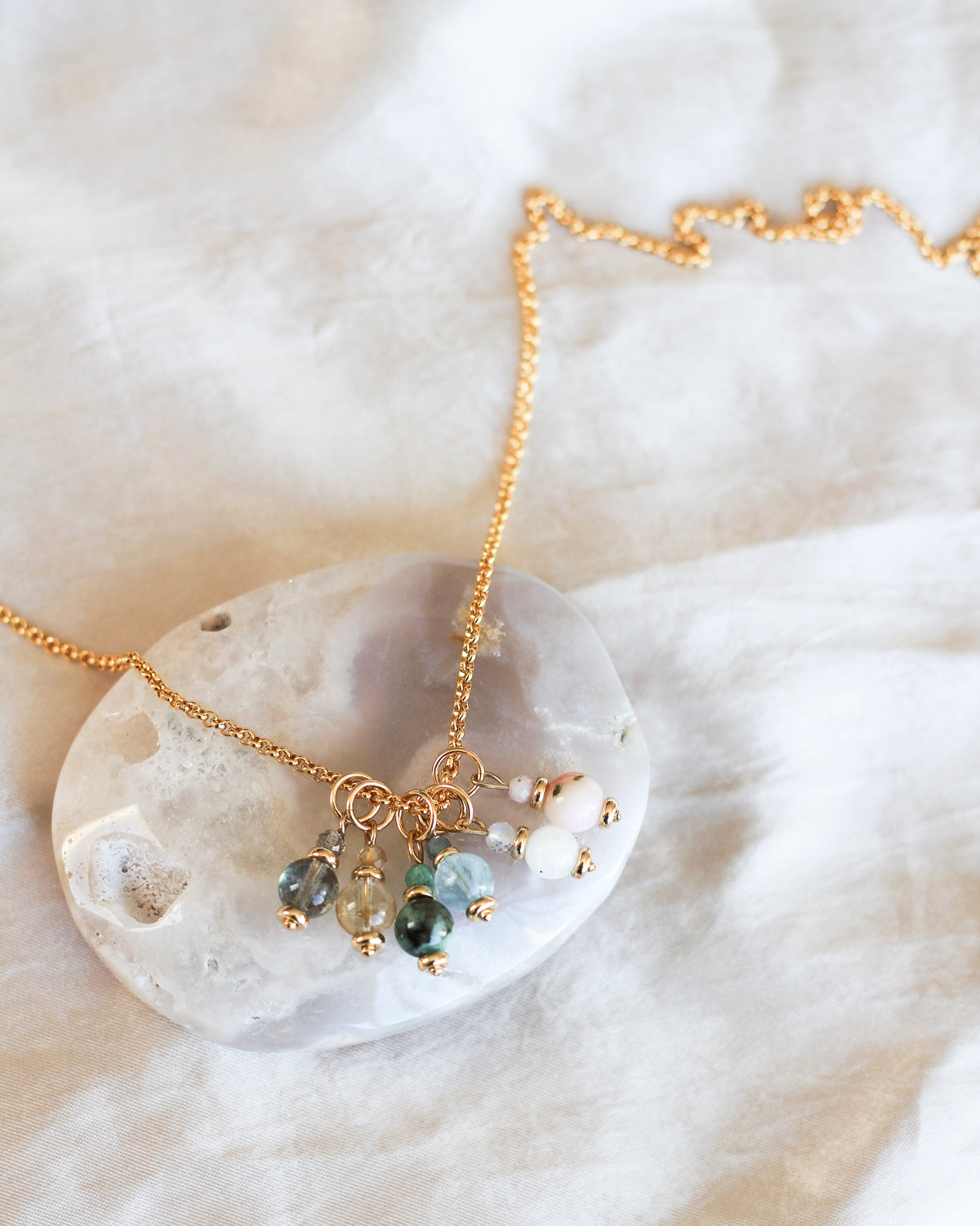 gold rolo chain layered with other charms