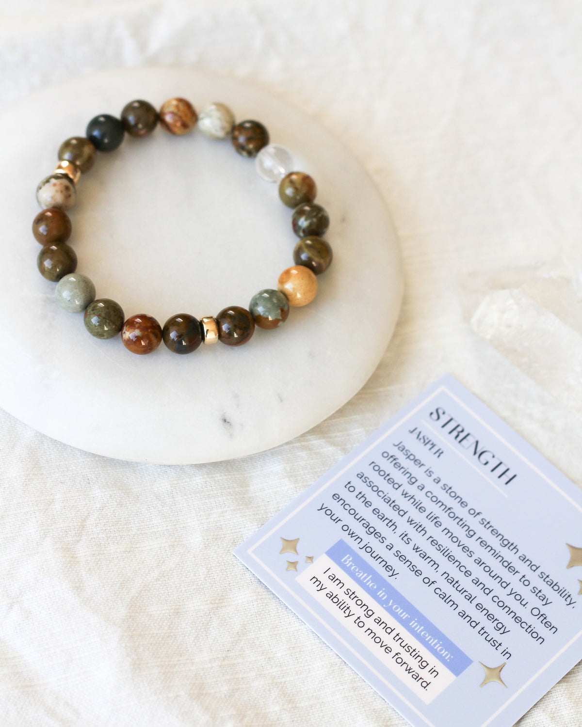 Close-up of smooth, round 8mm Jasper gemstone beads with natural earthy patterns.