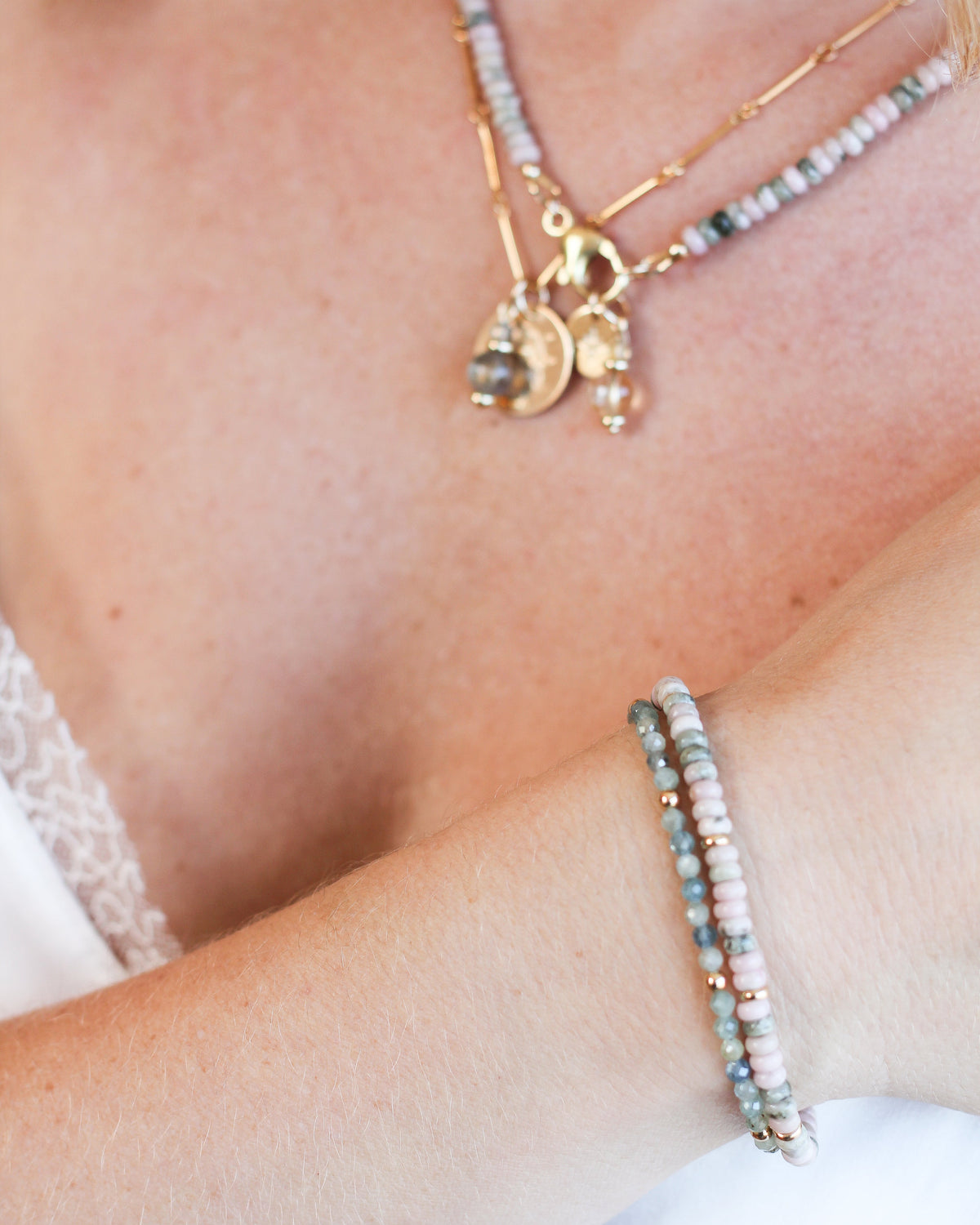 Delicate Kyanite beaded bracelet featuring blue and green gemstones, worn on the wrist.