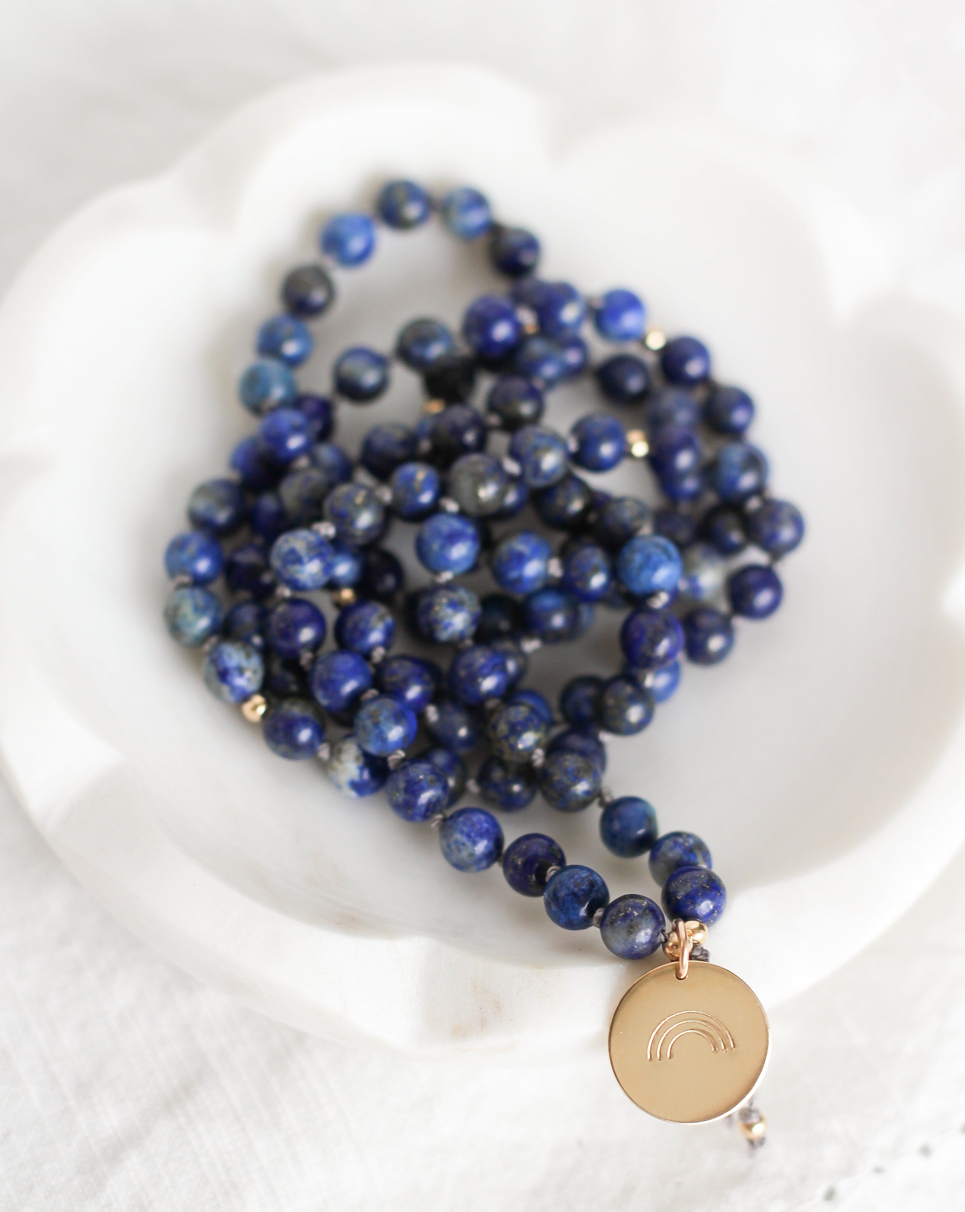 Wisdom Mala Pendant Necklace on dish