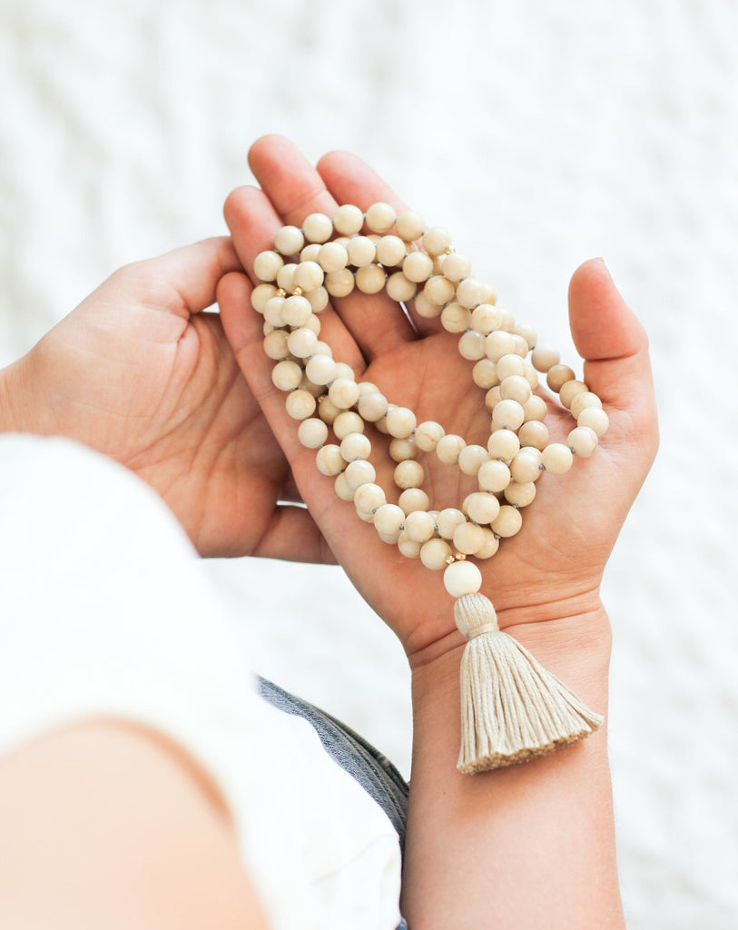Riverstone mala necklace in hand