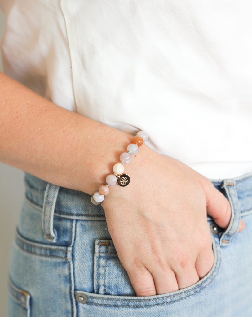agate mala beads bracelet with gold daisy charm on model