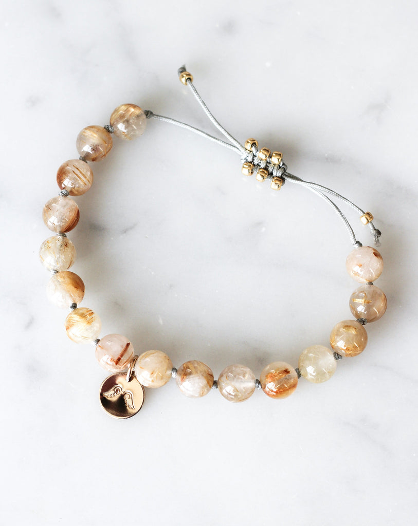 golden rutilated quartz mala bracelet with angel wings charm