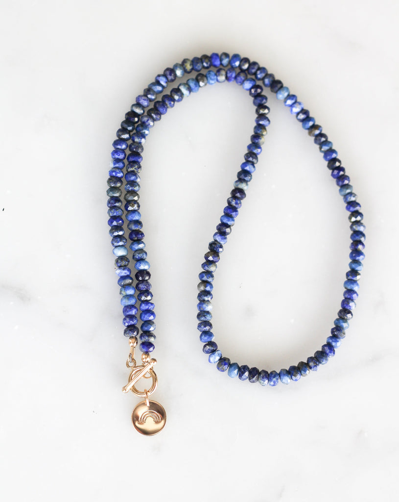 lapis lazuli intention necklace with gold rainbow charm